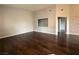 A spacious living room with hardwood floors and neutral paint, perfect for entertaining at 1881 W Alexander Rd # 1035, North Las Vegas, NV 89032