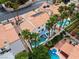 The aerial view shows the home's large pool, desert landscaping, and many mature palm trees at 2024 Spruce Brook Dr, Henderson, NV 89074