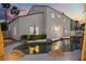 Charming backyard featuring a private pool with decorative rocks, palm trees, and well-maintained landscaping at 2024 Spruce Brook Dr, Henderson, NV 89074