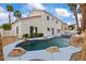Backyard featuring a rock-lined pool, spa, well-manicured landscaping, and palm trees at 2024 Spruce Brook Dr, Henderson, NV 89074