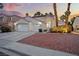 Charming home featuring a three-car garage, mature trees, landscape beds and a terra cotta roof at 2024 Spruce Brook Dr, Henderson, NV 89074