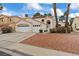 Inviting home with a three-car garage, manicured landscaping, terra cotta roof, and a welcoming entrance at 2024 Spruce Brook Dr, Henderson, NV 89074