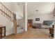View of a large living room and staircase with tile floors and neutral paint, great for relaxing and entertaining guests at 2024 Spruce Brook Dr, Henderson, NV 89074