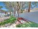 Grassy backyard with a built in sandbox feature near a long stone fence at 217 Windsong Dr, Henderson, NV 89074