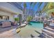 Backyard boasts a custom pool with rock waterfalls, a gazebo, and an outdoor living area for ultimate relaxation at 217 Windsong Dr, Henderson, NV 89074