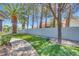 Green backyard featuring manicured landscaping and paved pathway at 217 Windsong Dr, Henderson, NV 89074