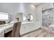 Luxurious primary bathroom featuring dual mirrors, ample counter space, and a walk-in shower with elegant tile work at 217 Windsong Dr, Henderson, NV 89074
