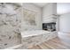 Beautiful bathroom features a soaking tub, shower, and marble fireplace, creating a spa-like retreat at 217 Windsong Dr, Henderson, NV 89074