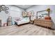 Charming bedroom with wood floors, a decorative wall, and natural light from the window at 217 Windsong Dr, Henderson, NV 89074