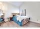 Cozy bedroom with vaulted ceilings, hardwood floors, a wood bed frame, and natural light at 217 Windsong Dr, Henderson, NV 89074