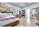 Spacious bedroom with wood floors, decorative accents, and a door to the walk-in closet at 217 Windsong Dr, Henderson, NV 89074