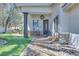 Inviting covered front porch with a seating area and well manicured landscaping at 217 Windsong Dr, Henderson, NV 89074