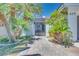 Landscaped front yard with lush green grass, mature trees, and a custom iron gate at 217 Windsong Dr, Henderson, NV 89074