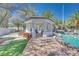 Poolside gazebo with rock water feature and wood pile at 217 Windsong Dr, Henderson, NV 89074