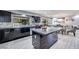 Modern kitchen featuring dark cabinets, stone countertops, an island and an open floor plan at 217 Windsong Dr, Henderson, NV 89074