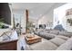 Spacious living room with vaulted ceiling, tile floors, large sectional couch and ample seating at 217 Windsong Dr, Henderson, NV 89074