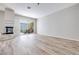 Bright living room with wood floors, a fireplace, and a sliding glass door to the backyard patio at 217 Windsong Dr, Henderson, NV 89074