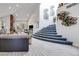 Open-concept living area with high ceilings, neutral decor, and a staircase to the upper level at 217 Windsong Dr, Henderson, NV 89074