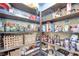 Walk-in pantry features ample wooden shelving for organized storage and patterned wallpaper at 217 Windsong Dr, Henderson, NV 89074