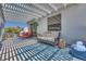 Relaxing patio featuring comfortable seating, a stylish rug, and a sun-shading pergola for outdoor entertaining at 217 Windsong Dr, Henderson, NV 89074