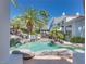 Backyard pool area with unique rock features and lush landscaping at 217 Windsong Dr, Henderson, NV 89074