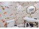 Unique powder room with koi wallpaper, stylish sink with gold fixtures and a round decorative mirror at 217 Windsong Dr, Henderson, NV 89074