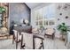 Bright sitting area with light flooring, shuttered windows and decorated with houseplants and a chalkboard accent wall at 217 Windsong Dr, Henderson, NV 89074