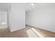 Bedroom with neutral walls, carpet and ceiling fan with view into bathroom at 2191 Bay Club Dr # 204, Laughlin, NV 89029