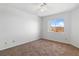 Neutral bedroom with tan carpet and views to mountains through a bright window at 2191 Bay Club Dr # 204, Laughlin, NV 89029