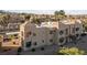 Tan condos featuring private balconies, desert landscaping, and tiled roofs in a well-maintained community at 2191 Bay Club Dr # 204, Laughlin, NV 89029