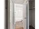 Hallway view to bathroom with tile floor through open closet doors at 2191 Bay Club Dr # 204, Laughlin, NV 89029