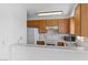 Bright kitchen featuring wood cabinets, white appliances, and an eat-in counter at 2191 Bay Club Dr # 204, Laughlin, NV 89029