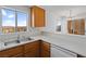 Kitchen with wood cabinets, sink with view, dishwasher, and slider to patio at 2191 Bay Club Dr # 204, Laughlin, NV 89029