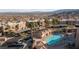 Community pool area surrounded by palm trees and seating in a complex with mountain views at 2191 Bay Club Dr # 204, Laughlin, NV 89029