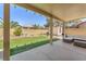 Inviting covered back patio with seating area, lawn, landscaping, and storage shed at 2268 Alanhurst Dr, Henderson, NV 89052