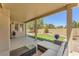 Comfortable covered back patio with seating area, artificial grass lawn, and landscaped yard at 2268 Alanhurst Dr, Henderson, NV 89052