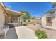Backyard featuring a covered patio, well-maintained lawn, storage shed, and mature landscaping at 2268 Alanhurst Dr, Henderson, NV 89052