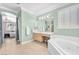 Bright bathroom featuring a soaking tub, vanity and access to the main bedroom at 2268 Alanhurst Dr, Henderson, NV 89052