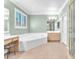 Well-lit bathroom with large soaking tub, separate shower, and vanity area at 2268 Alanhurst Dr, Henderson, NV 89052