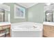 Bright bathroom featuring a soaking tub with jets, vanity, and natural light at 2268 Alanhurst Dr, Henderson, NV 89052