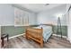 Bedroom featuring stylish wood floors, window with shutters, and neutral color scheme at 2268 Alanhurst Dr, Henderson, NV 89052