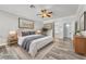 Comfortable primary bedroom with ensuite bathroom, wood-look flooring and neutral decor at 2268 Alanhurst Dr, Henderson, NV 89052
