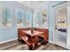 Charming breakfast nook with wood table, benches, and abundant natural light from shuttered windows at 2268 Alanhurst Dr, Henderson, NV 89052