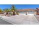 A well-maintained home with a spacious driveway and three-car garage at 2268 Alanhurst Dr, Henderson, NV 89052