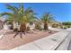 Well maintained front yard with mature palm trees and desert landscaping at 2268 Alanhurst Dr, Henderson, NV 89052
