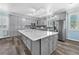 Spacious kitchen features gray cabinets, stainless steel appliances, a large island, and stylish backsplash at 2268 Alanhurst Dr, Henderson, NV 89052