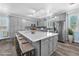 Spacious kitchen featuring an oversized island with seating, grey cabinets, and stainless steel appliances at 2268 Alanhurst Dr, Henderson, NV 89052