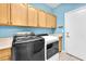 Modern laundry room with front loading washer and dryer, ample storage, and natural light at 2268 Alanhurst Dr, Henderson, NV 89052