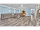 Spacious living room with tile floors, fireplace, dining area, and comfortable sectional sofa at 2268 Alanhurst Dr, Henderson, NV 89052