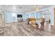 Open concept living room with wood-look tile flooring, dining area, and comfortable seating at 2268 Alanhurst Dr, Henderson, NV 89052